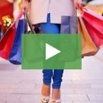 clickable video thumbnail depicting a woman holding a large amount of shopping bags