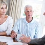 a tax expert talks with an older couple about their financial options
