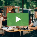 clickable video thumbnail showing two young man and young women working on laptops wile drinking coffee