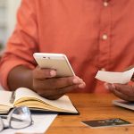 a man checks his receipt with his online banking app