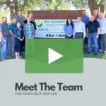 clickable video thumbnail showing the resource center's staff and employees next to their sign